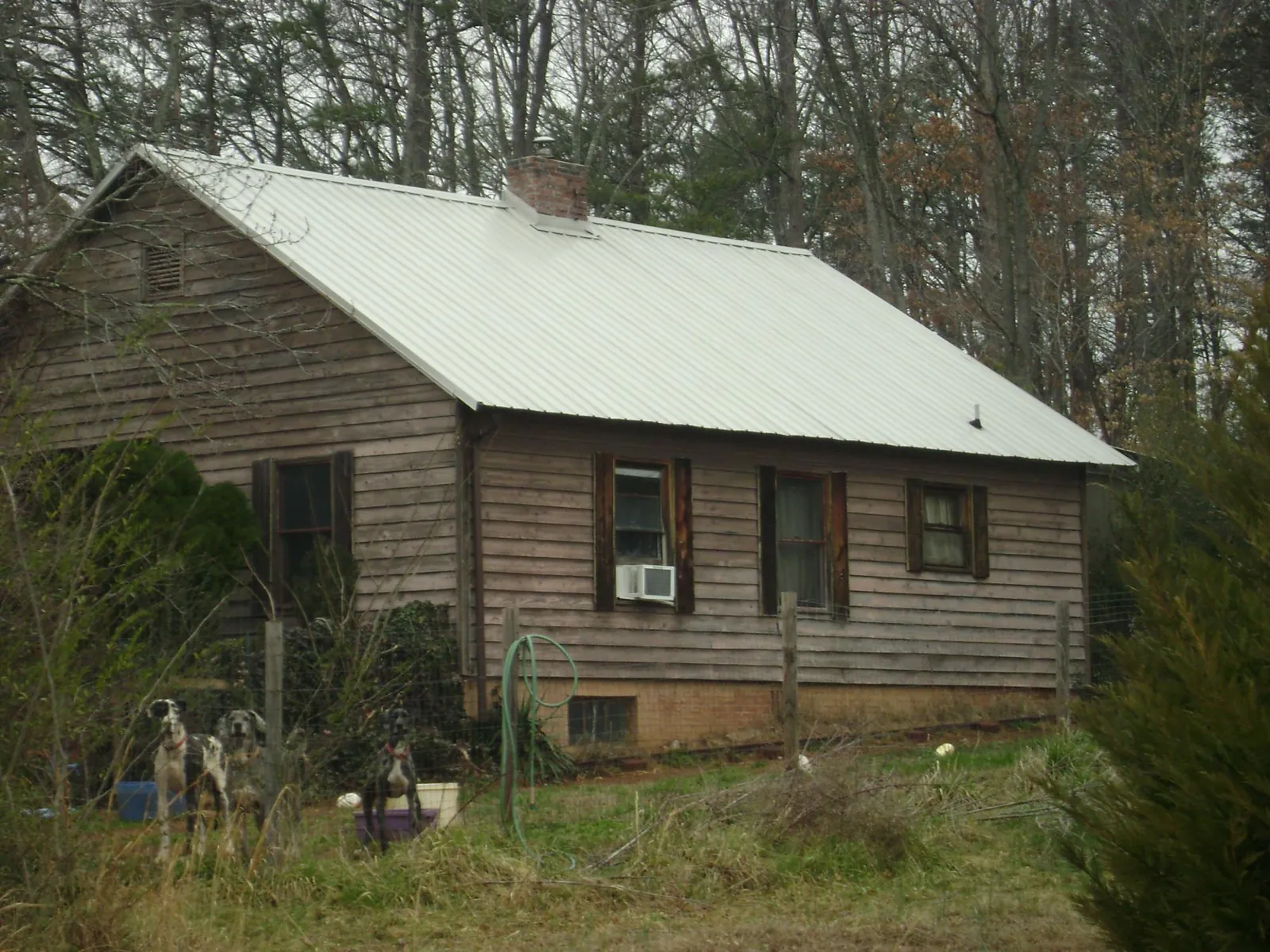White metal roof on an old wood sided farmhouse, from a Metal Roof Installation job in Byram
